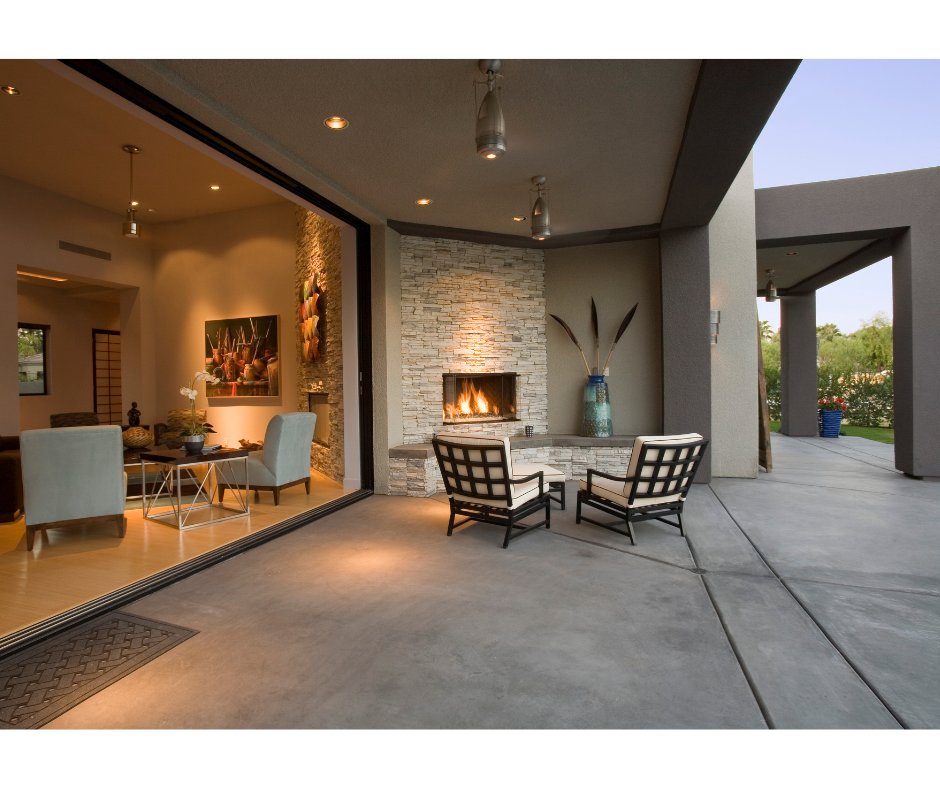 Modern outdoor concrete patio with fireplace and seating area