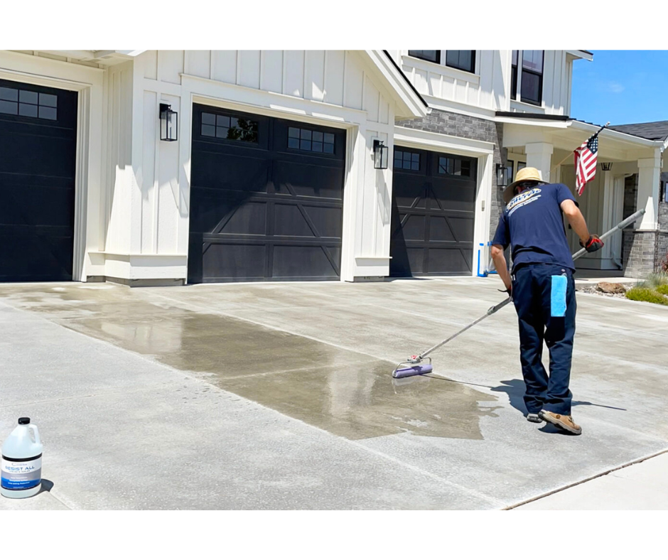 solid concrete services applying concrete sealer on a driveway.