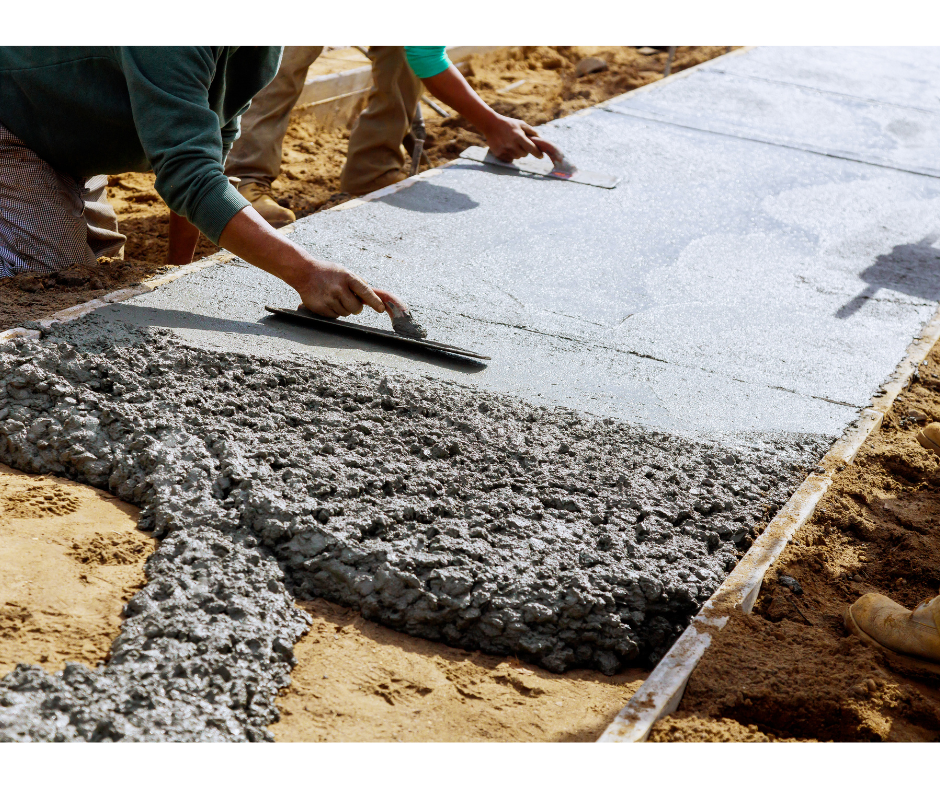 Person working with concrete on a construction site