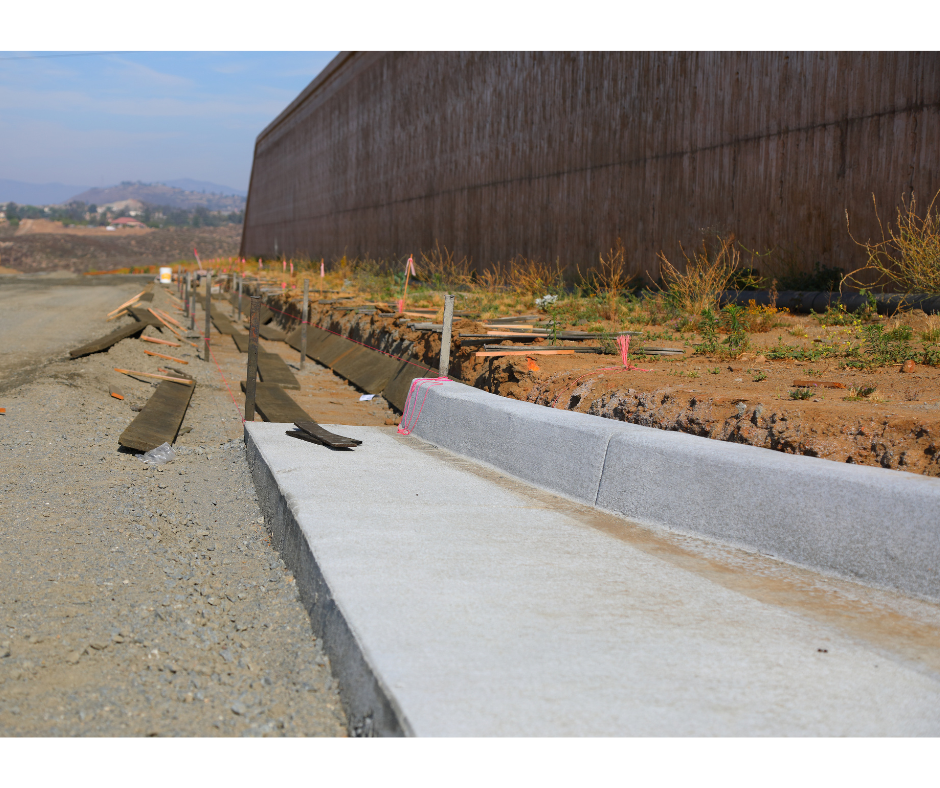 Construction site with concrete pavement and concrete curb and gutter