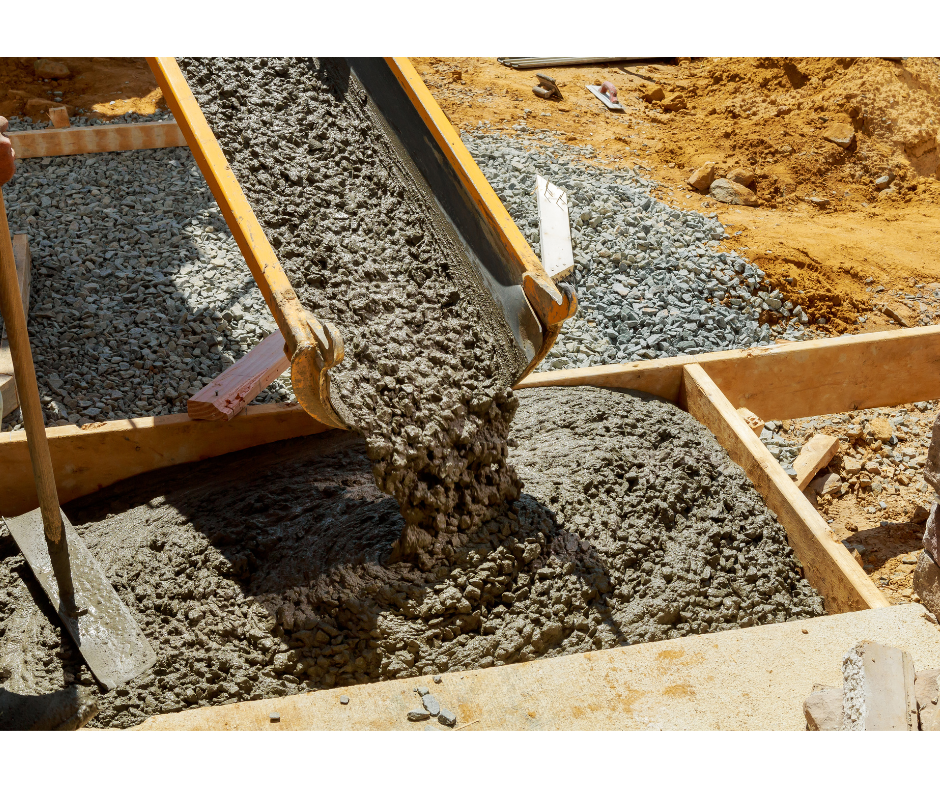 Concrete being poured into wooden forms on a construction site
