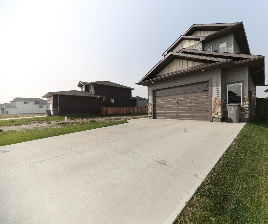 Two-story house with a garage and driveway in a IL suburban neighborhood.